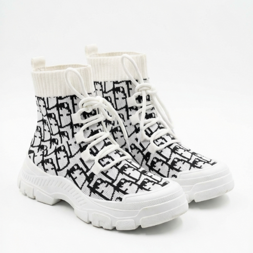 Paire de bottines chaussette à tige élastique, disposées côte à côte en angle trois-quarts sur fond neutre. 